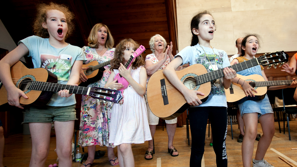 Children playing guitars at a Sparks Family Create event